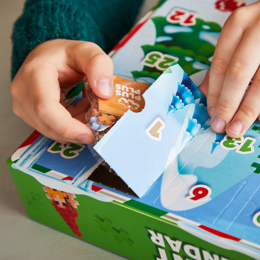 Plus-Plus Advent Calendar 2024: hands opening a calendar door