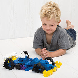 Boy playing with BIG 100 pc race car builds