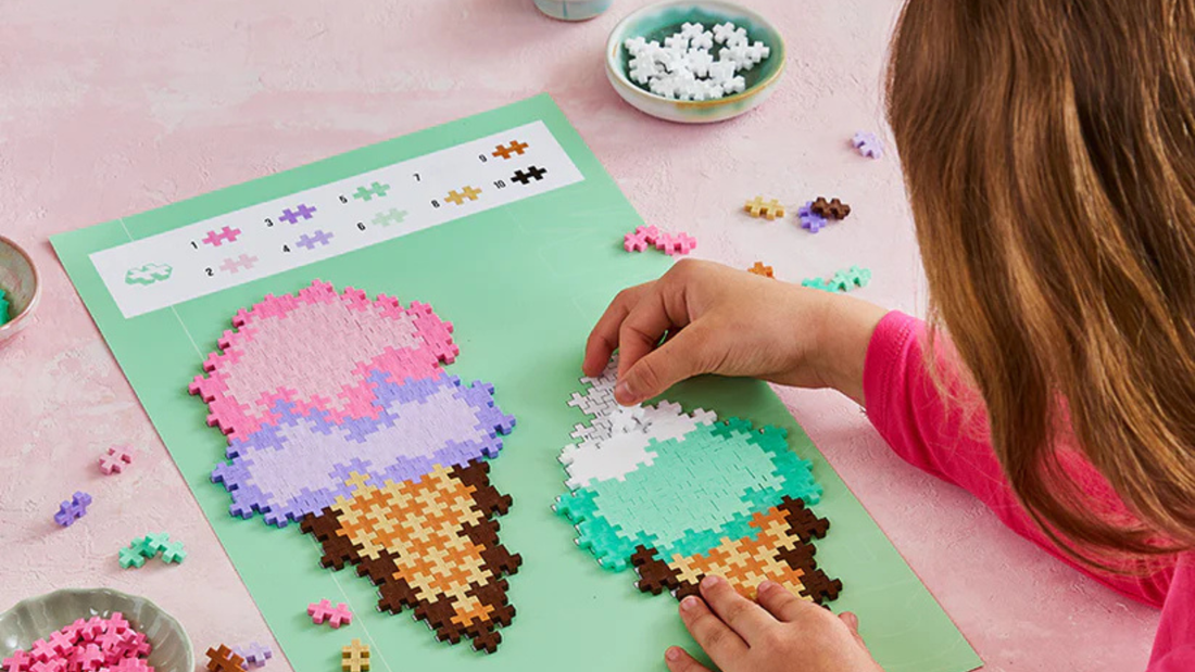 child doing Plus-Plus puzzle by number set