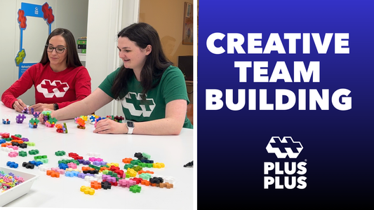 two plus-plus staff working on team building activity with Plus-Plus blocks