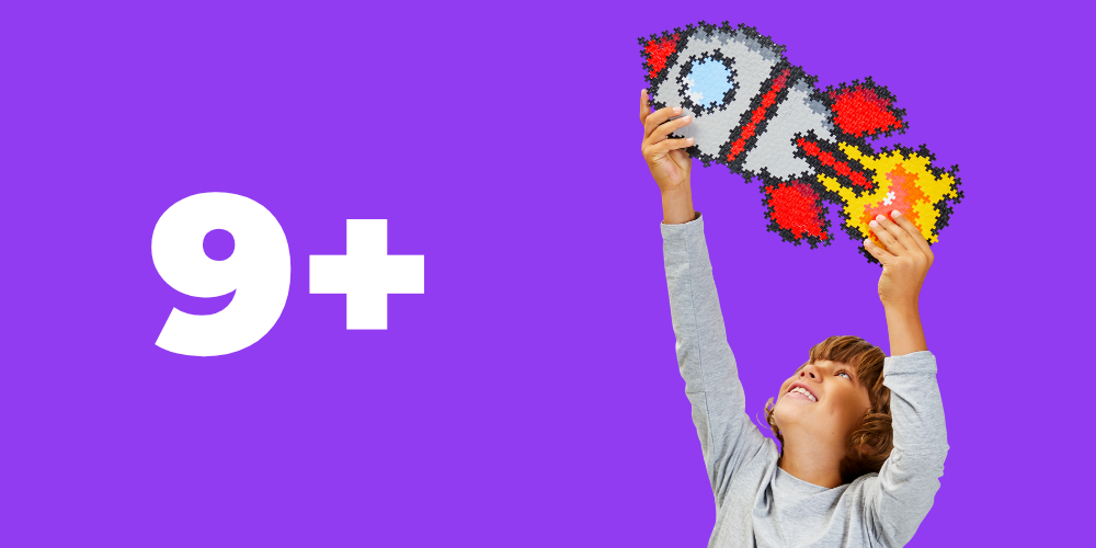 Ages 9+: boy holding up a large Plus-Plus rocket build on a purple background