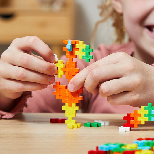 600 pc Open Play Mix - Rainbow: child building a colorful rainbow figure on a table